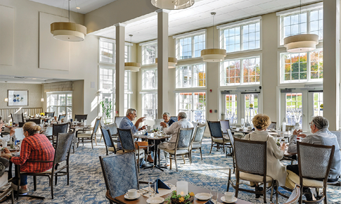 A group of people are sitting in a restaurant, enjoying their meals. AI generated content