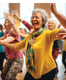 A woman wearing a yellow shirt and a scarf is laughing and smiling while dancing. AI generated content