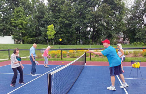 A group of people playing tennis on a court. AI generated content